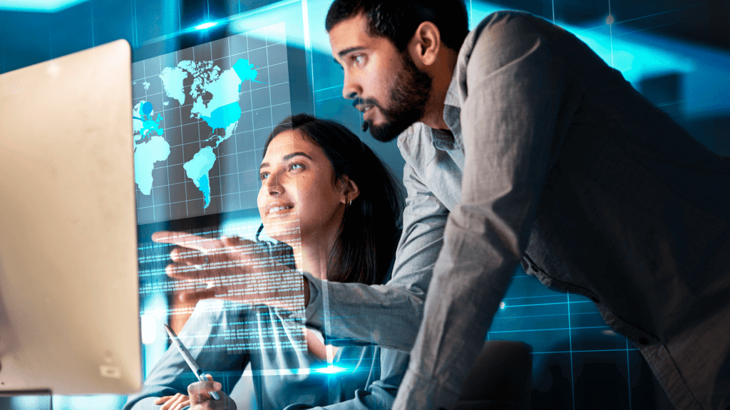 The image shows two professionals working on the computer, symbolizing the relevance of nearshore software outsourcing.