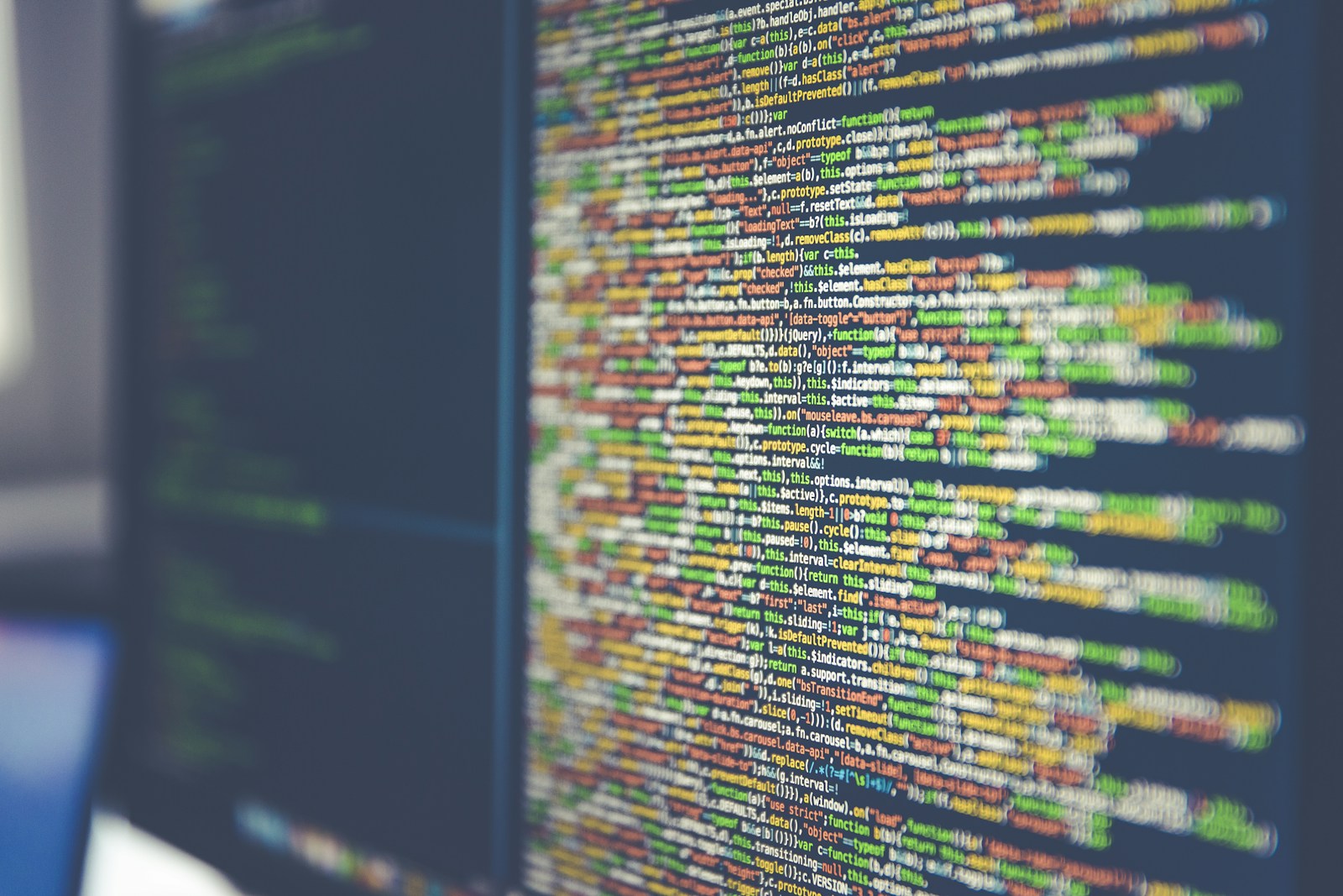 Colorful programming code on a monitor representing multi-agent orchestration in production