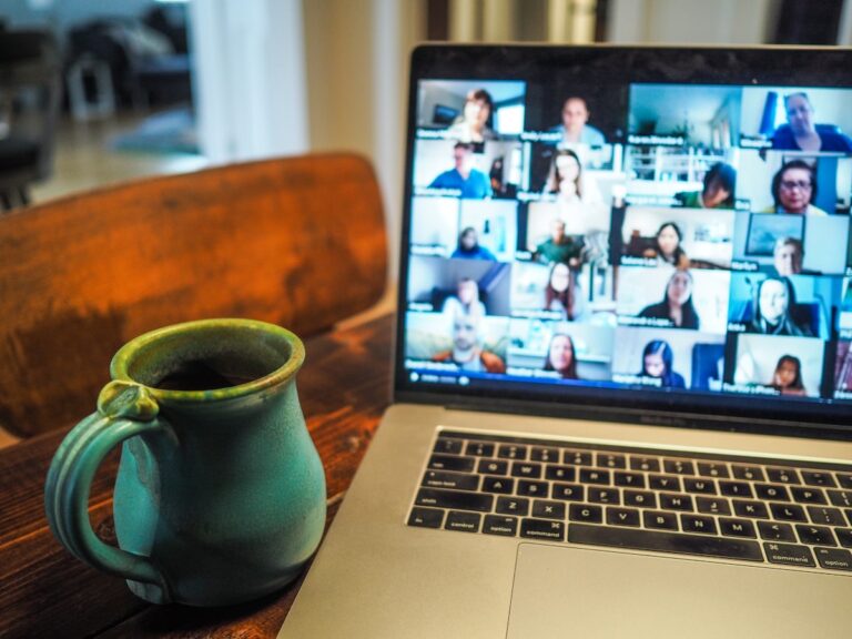 Professional team collaborating remotely via video call on MacBook Pro — illustrating nearshore real-time collaboration across time zones